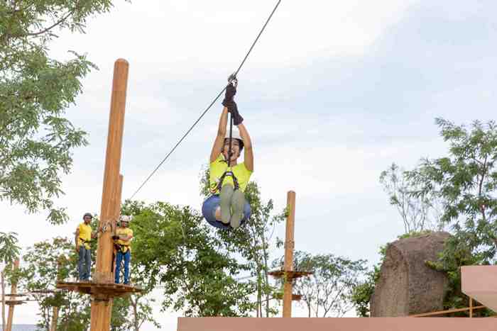 Adventure enthusiast ziplining over scenic views at Ramoji Film City